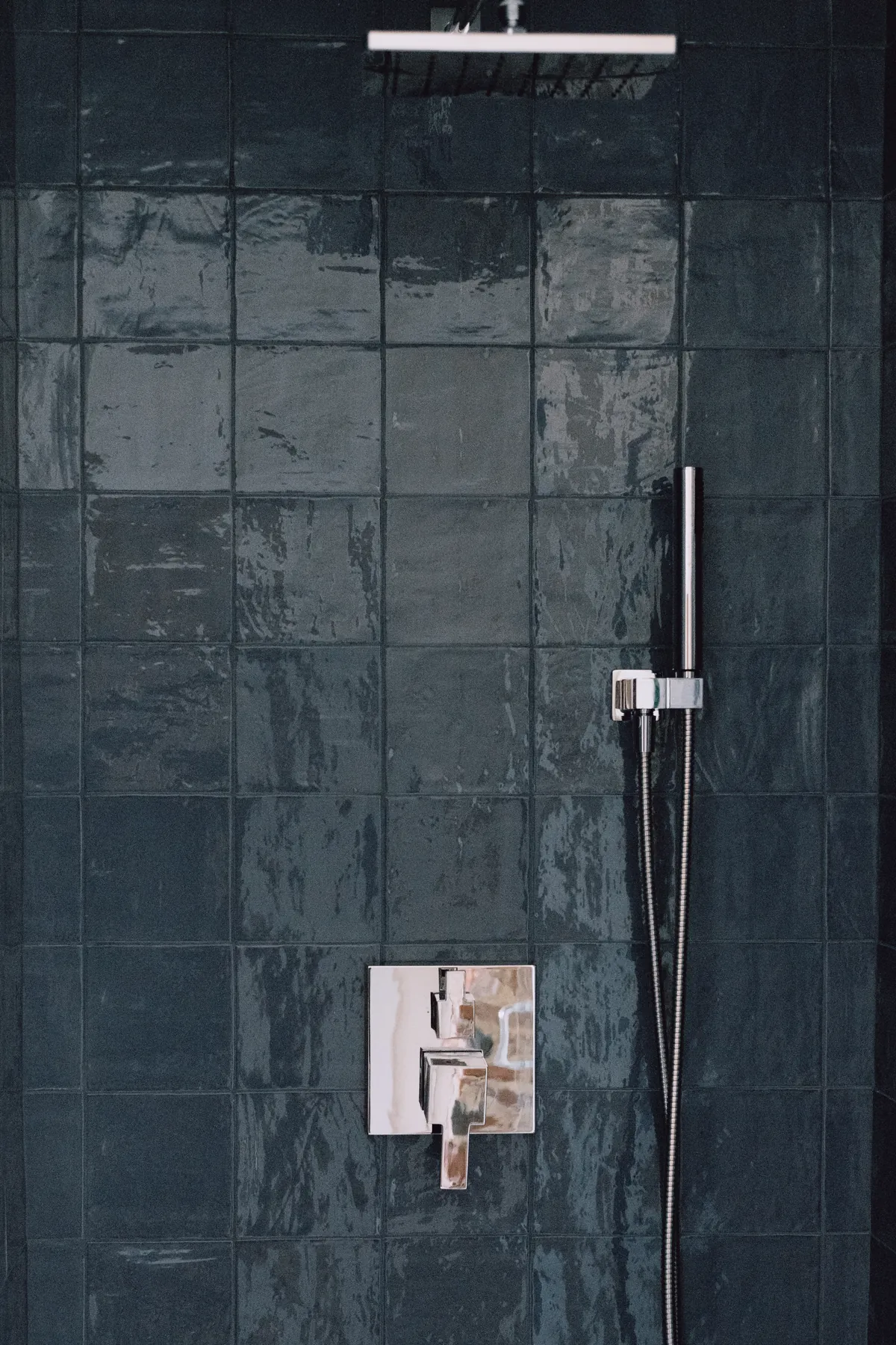 Nightingale Room shower with dark teal glazed tile, rain head and handheld sprayer